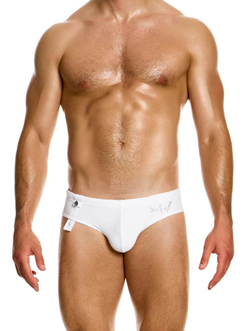 A model wearing white Modus Vivendi Diamonds swim brief with crystal stone branding and adjustable drawstrings.