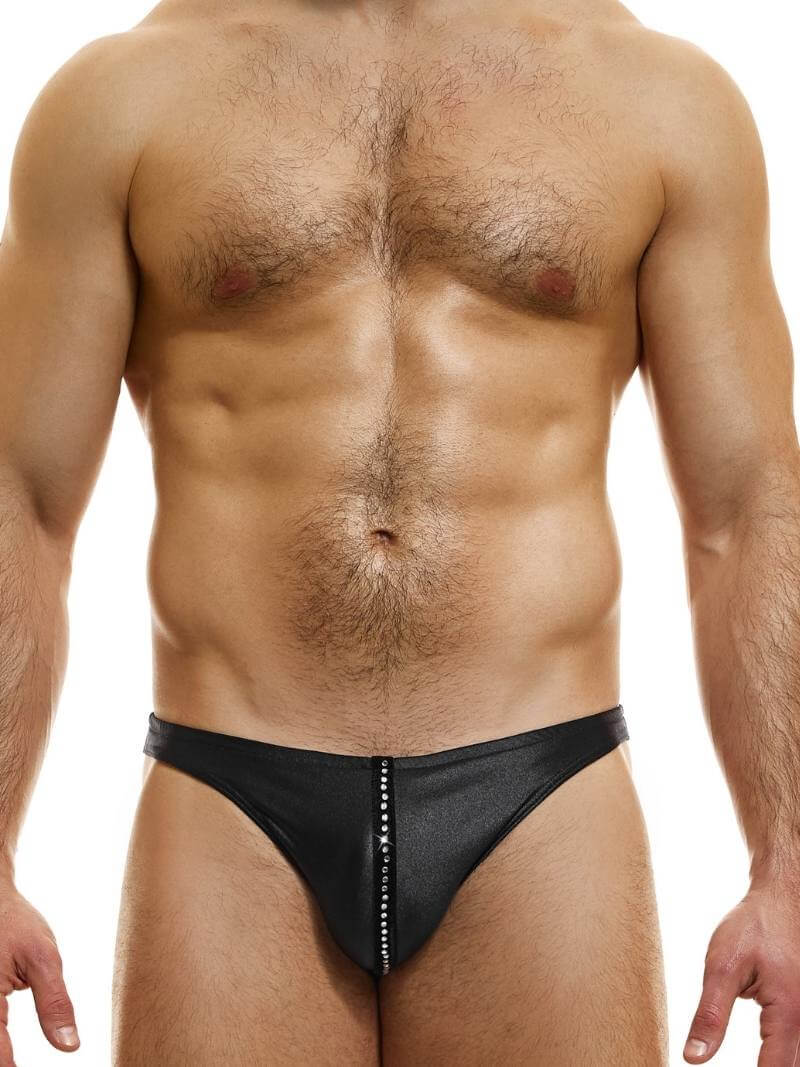 A man wearing a black micro brief bikini with a low-rise waist and crystal embellishments on the pouch.