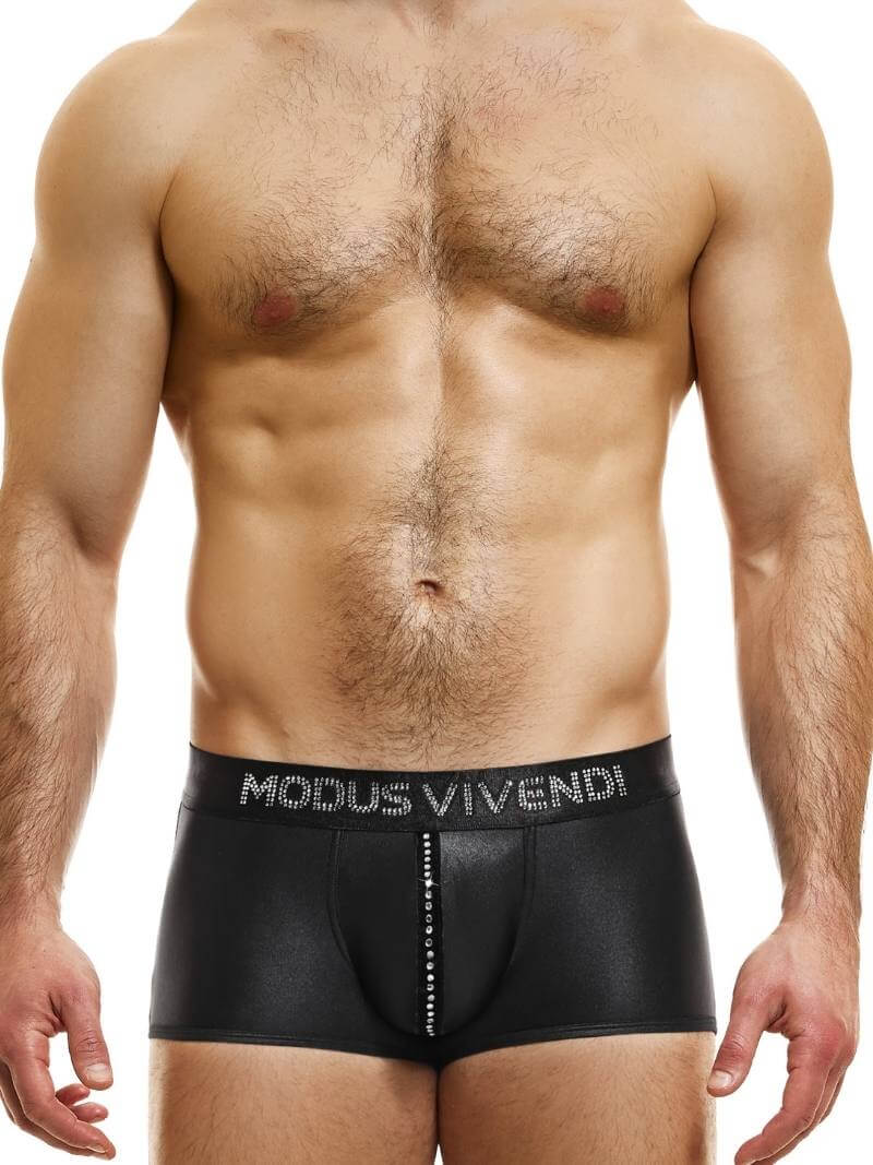 A model wearing black shiny boxer shorts with a velvet and crystal pouch stripe and crystal stone Modus Vivendi branding on the waistband.