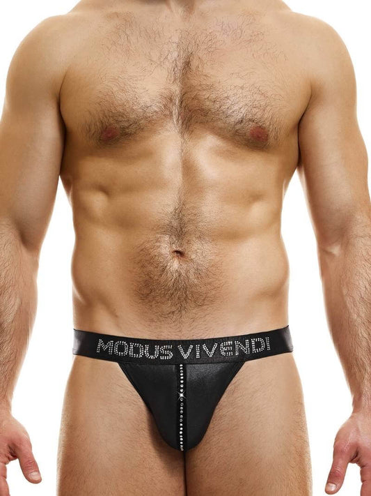 A model wearing a black thong with a shiny satin look, featuring a velvet and crystal pouch stripe and crystal stone Modus Vivendi branding.