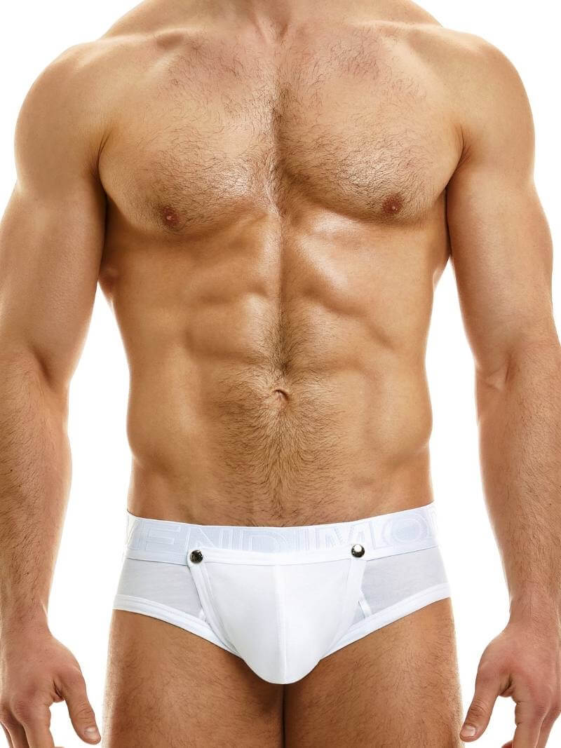 This image features a model wearing the Modus Vivendi Hole Brief, which showcases a classic black colorway with a matching shiny and branded waistband. The brief is designed with an daring and provocative feature of a removable pouch, which is fastened with metal poppers and can be removed for a crotchless appearance.