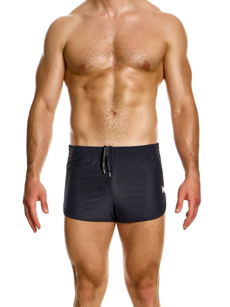 A man wearing blue jogging-style gym shorts with a drawstring waist.