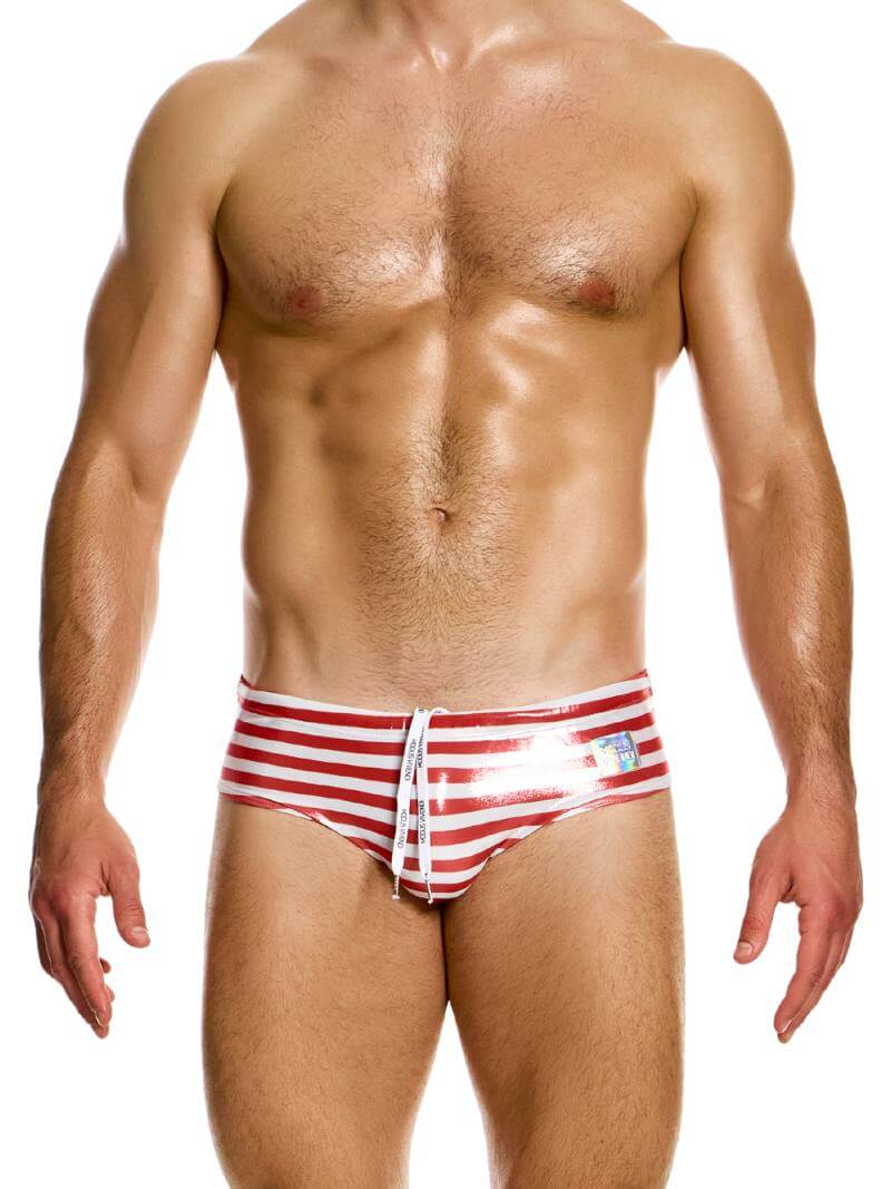 A model wearing blue striped swim briefs with a shiny holographic Modus Vivendi brand label on the waistband.