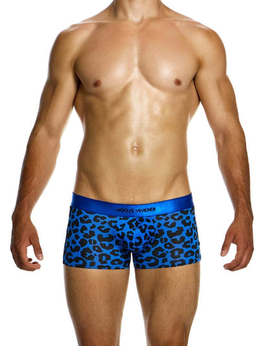 A model wearing red boxer briefs with a black leopard animal print design, featuring a shiny branded waistband and a low-cut waist.