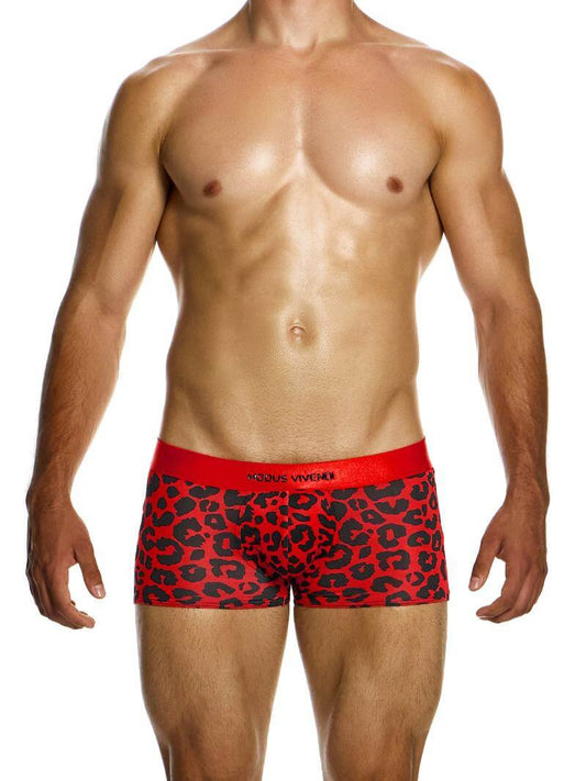 A model wearing red boxer briefs with a black leopard animal print design, featuring a shiny branded waistband and a low-cut waist.