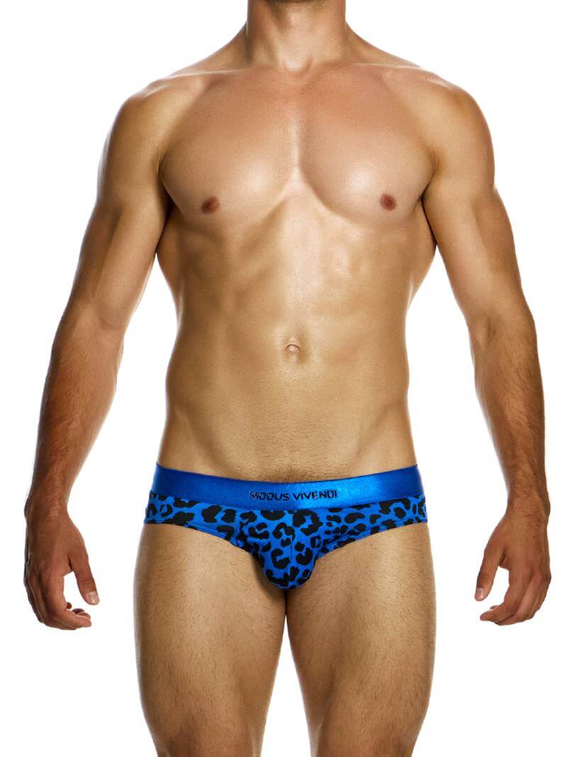 A male model wearing a blue leopard print brief with a shiny waistband featuring the Modus Vivendi branding.