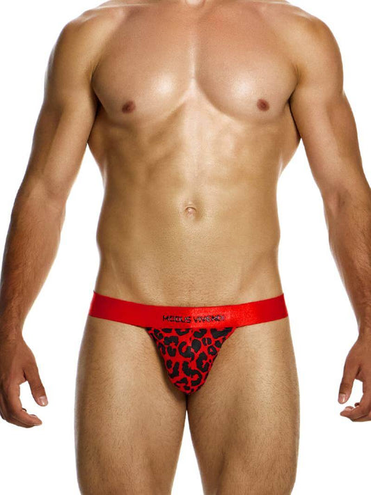 A male model wearing a red and black leopard print thong with a shiny waistband featuring the Modus Vivendi branding.