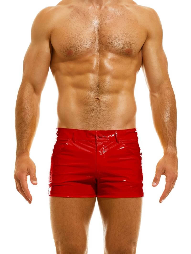 A man wearing red PVC vinyl 5 pocket shorts with a zip-up fly, button fastening, belt loops, and a thermo logo on the back pocket.