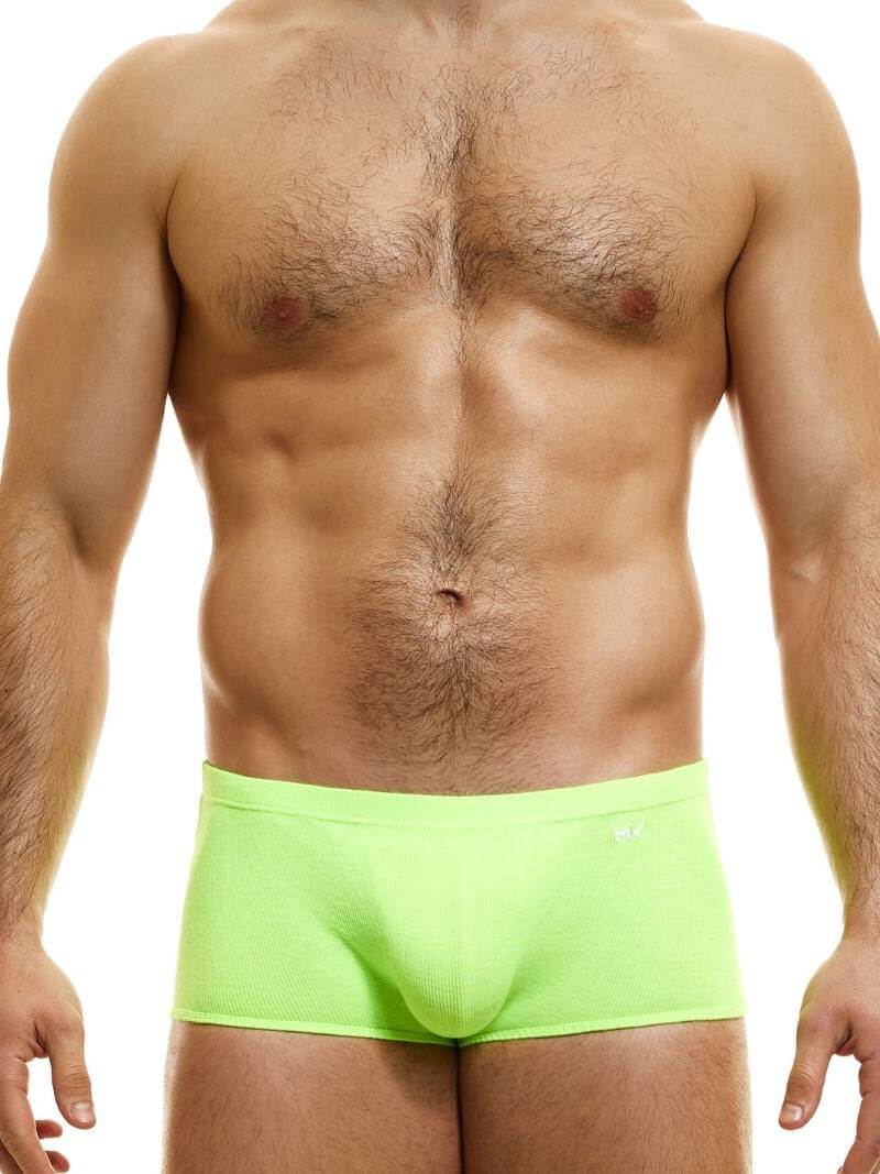 A model wearing blue Brazil-cut boxer underwear with a low-rise waistband and a small MV logo below the waistband.