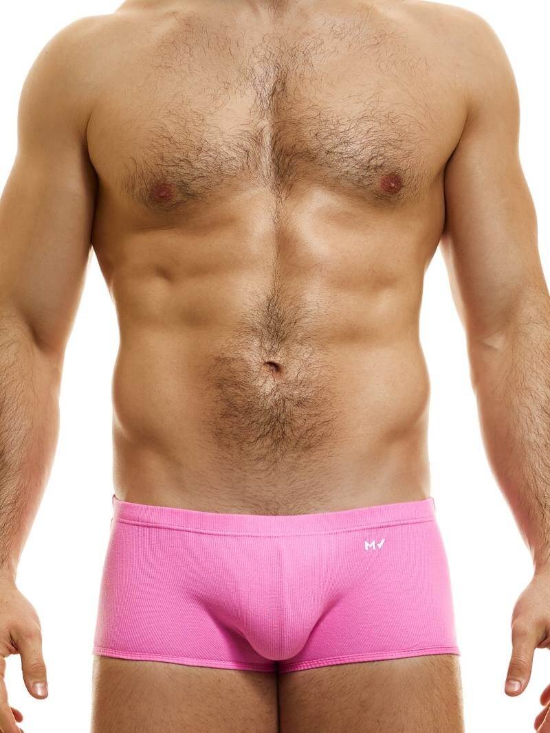 A model wearing blue Brazil-cut boxer underwear with a low-rise waistband and a small MV logo below the waistband.