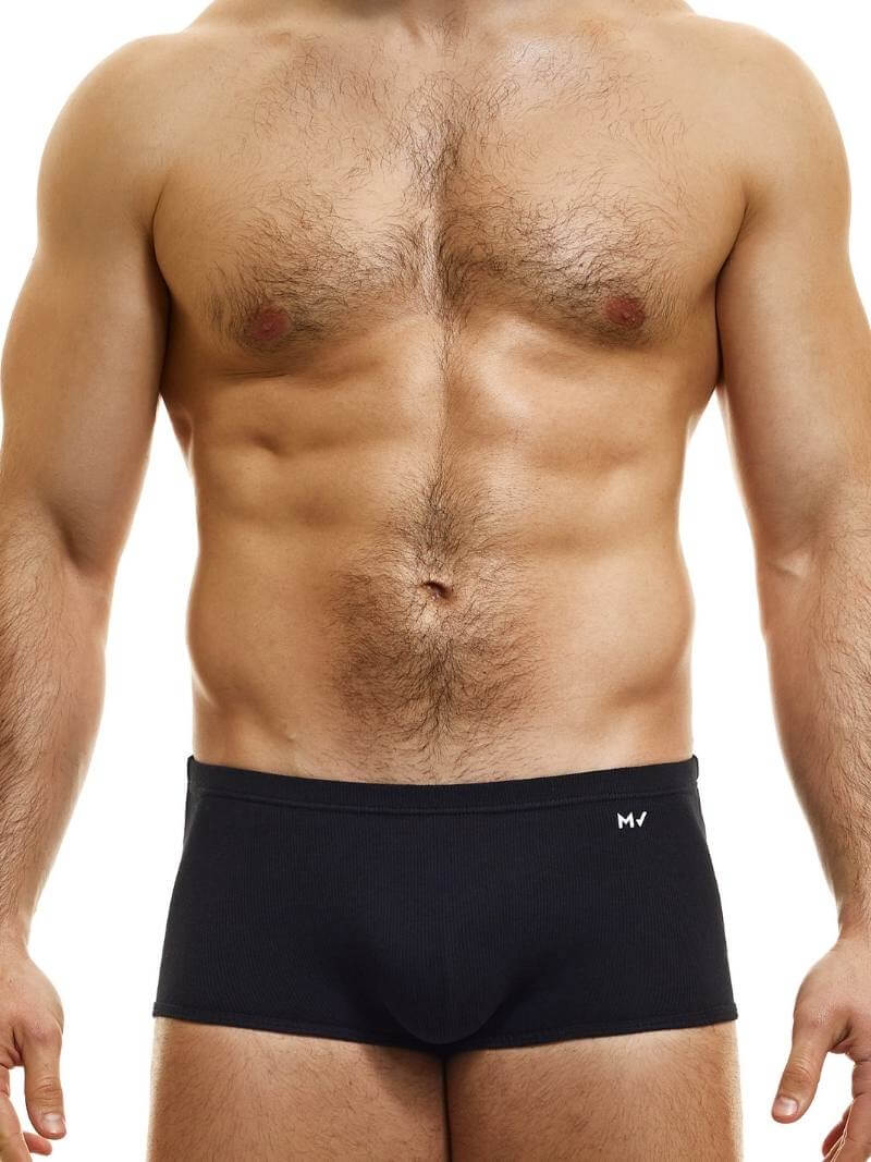 A model wearing blue Brazil-cut boxer underwear with a low-rise waistband and a small MV logo below the waistband.