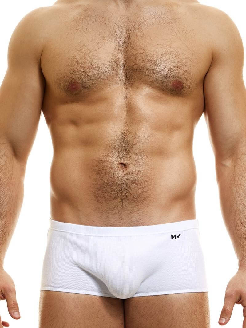 A model wearing blue Brazil-cut boxer underwear with a low-rise waistband and a small MV logo below the waistband.