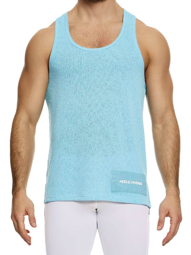 A male model wearing a long-length, round scoop neck, racer back, and straight fit pink knitted tank top with a linen panel on the back.