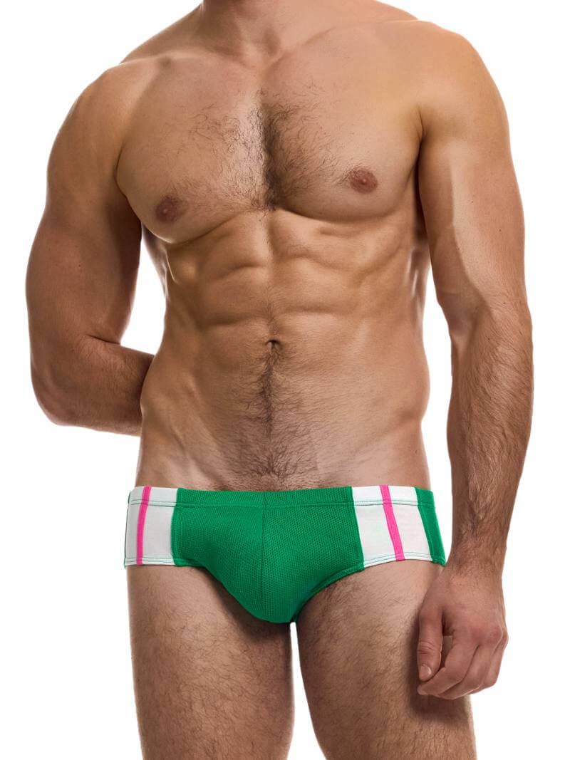 A model wearing a green retro micro brief with red and white stripes on the waistband.