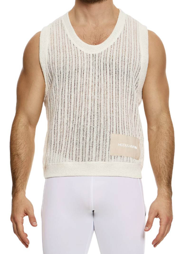 A male model wearing a light-colored, scoop neck, striped knit crochet tank top with a linen placket featuring the Modus Vivendi branding.