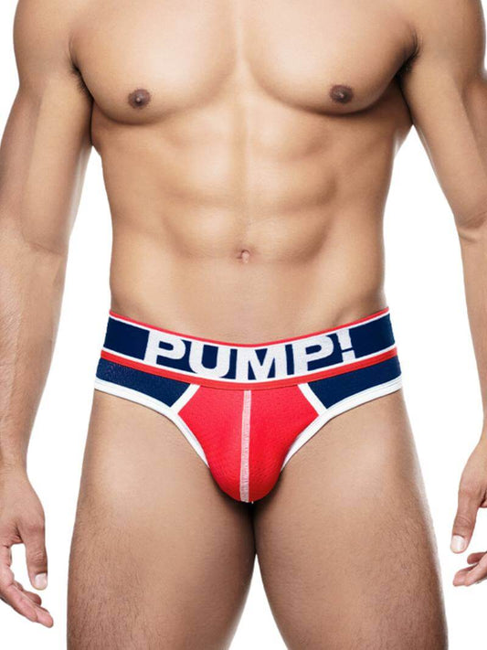 This image features the PUMP Underwear Big League Thong, designed for both style and comfort. The thong has a striking contrast with a navy and red color scheme and sports a multi-panel body that adds to its aesthetic appeal.