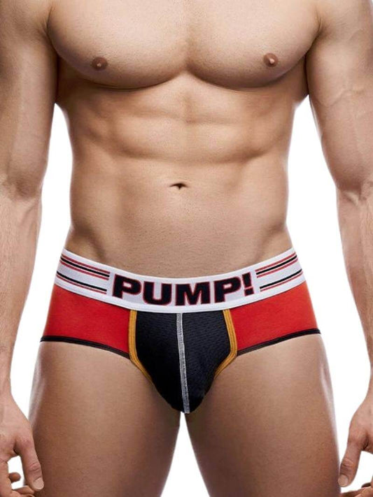 A model wearing PUMP Underwear Circuit Brief with contrasting red and black body, yellow and black piping, and a elasticated waistband with PUMP branding.