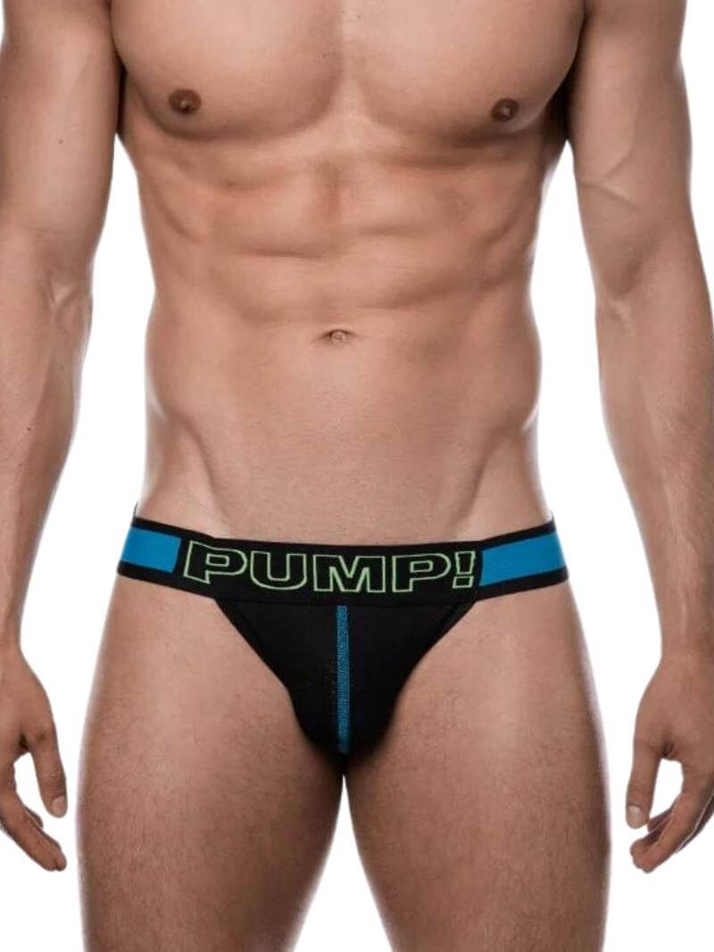 A man wearing a black mesh jockstrap with blue straps and PUMP branding on the waistband.
