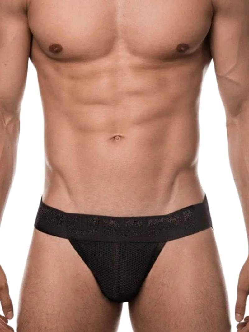 A man wearing a black PUMP Underwear Switch Breathable Mesh Jockstrap with a contoured pouch and elasticated trims.