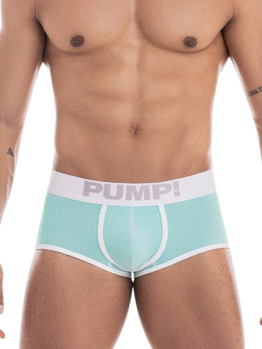 A model wearing a PUMP Underwear Milkshake Cotton Access Backless Trunk in a pastel color with white stitching and trims. The underwear is low-rise with a wide elasticated waistband featuring PUMP! branding.