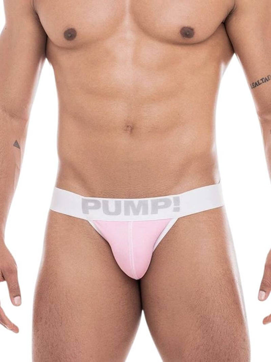 A model wearing a PUMP Underwear Milkshake Cotton Jockstrap in a pastel green color with white stitching and a elasticated waistband with PUMP! branding.