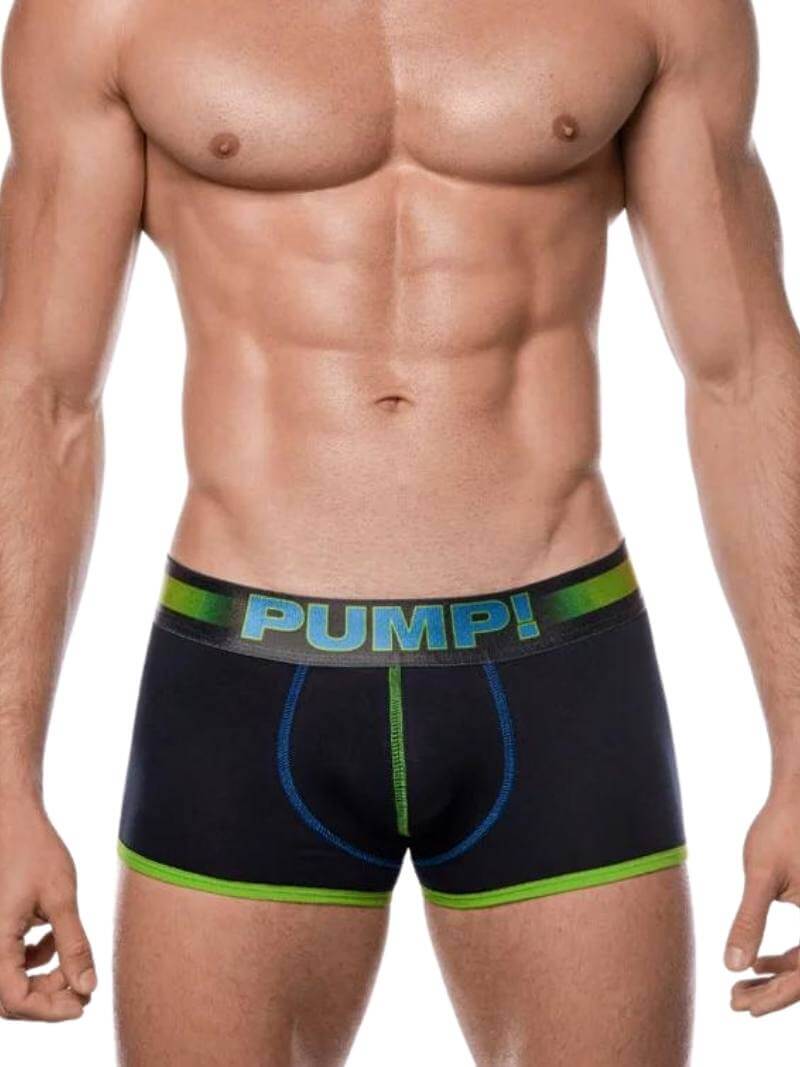 A model wearing black PUMP underwear with colored trims and a striped waistband. The underwear is low-rise and features a contoured pouch.
