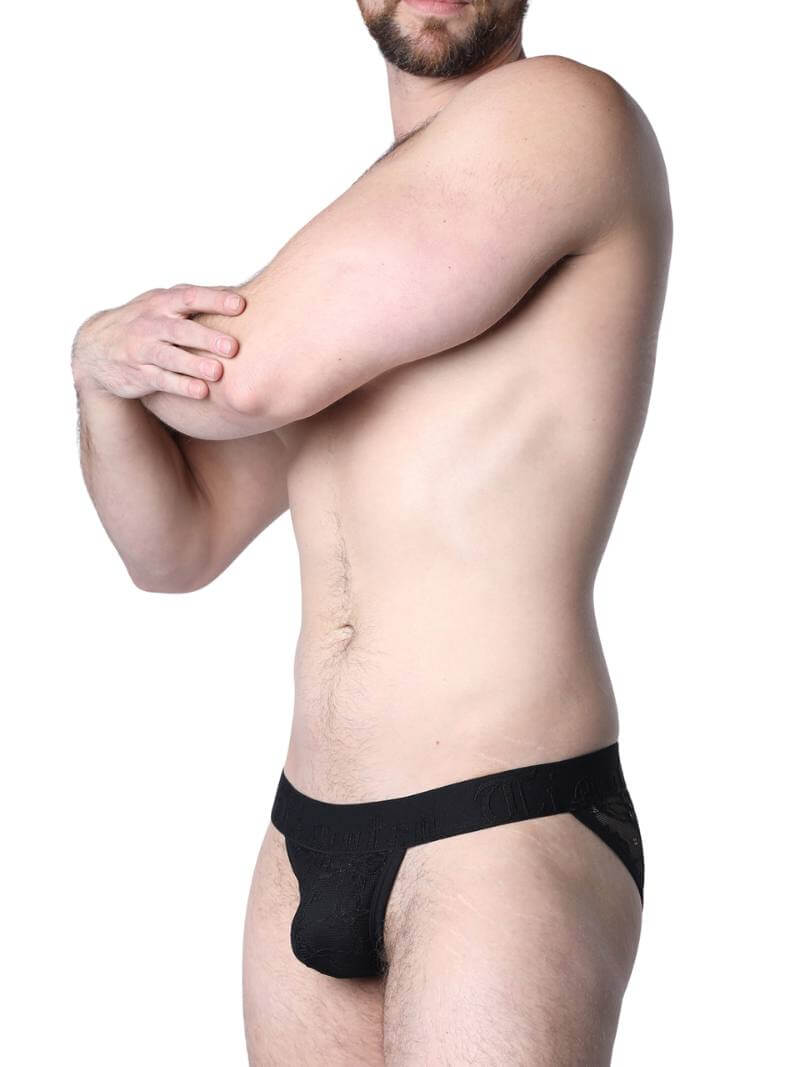 Man wearing black lace underwear in an urban setting