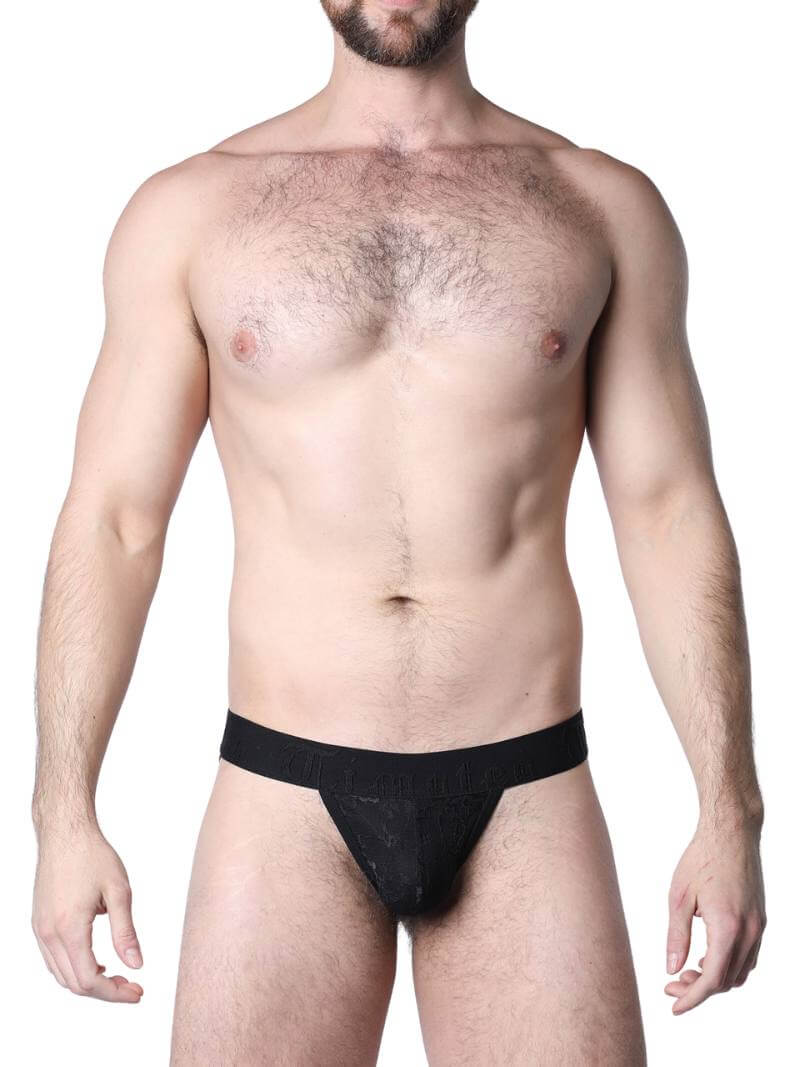 Man wearing black lace underwear in an urban setting