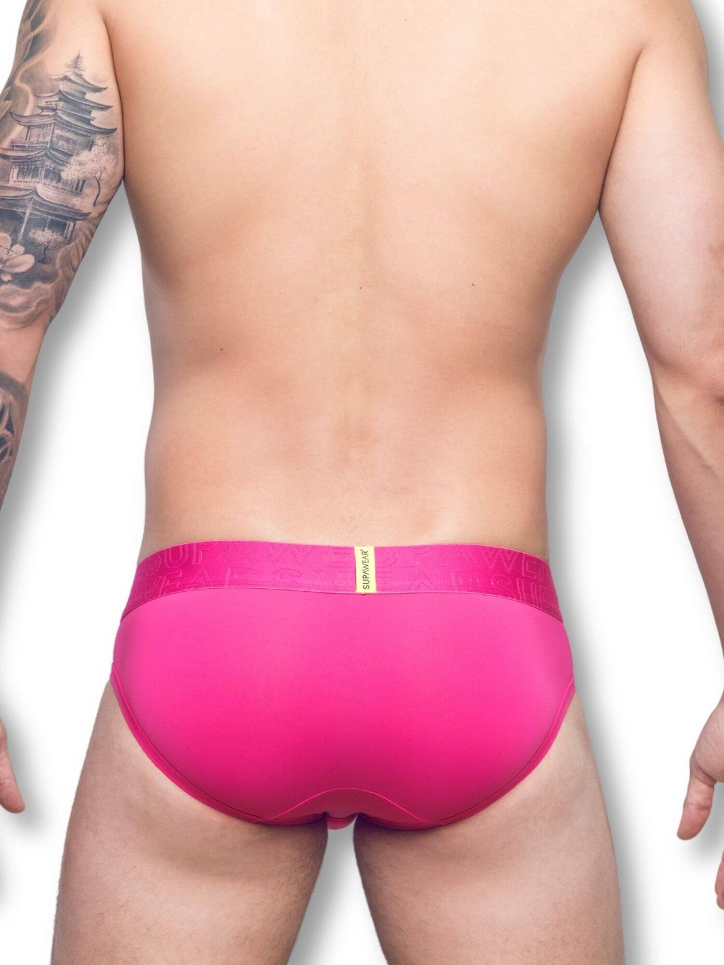 Person wearing bright pink underwear on a white background