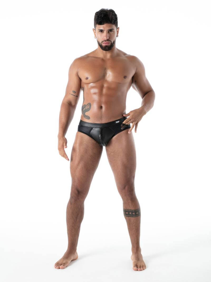 Man wearing black leather-like underwear on a white background