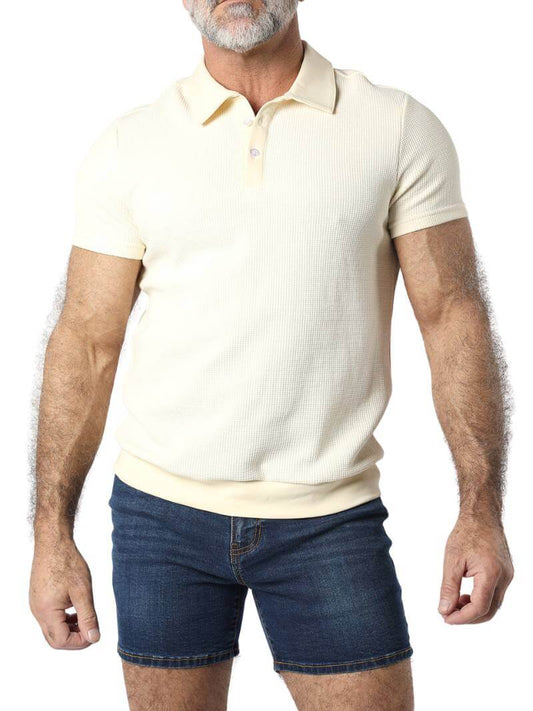 A male model wearing a pink Timoteo Indio polo shirt with short sleeves and a collared neck.