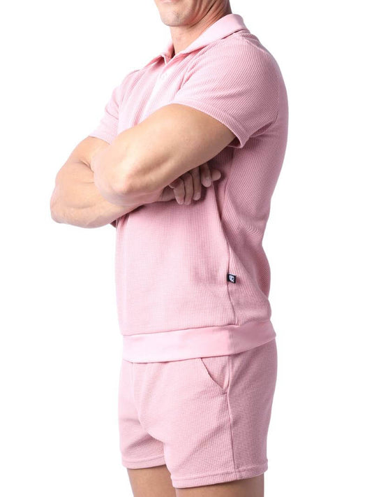 Close-up of a pink checkered garment with a focus on texture and pattern.