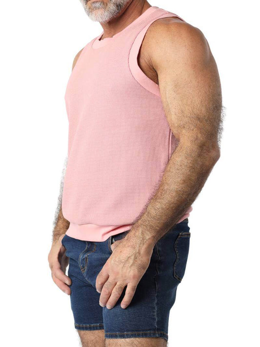 Close-up of a person wearing a pink sleeveless shirt on a white background
