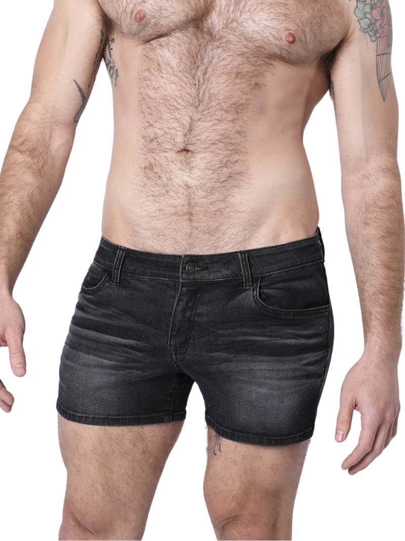 A pair of denim booty shorts with a low-rise waist and a 4-inch inseam, featuring a zipper fly, button fastening, belt loops, and four pockets. The shorts are blue with contrast stitching, and there is a leather branded patch on the back.