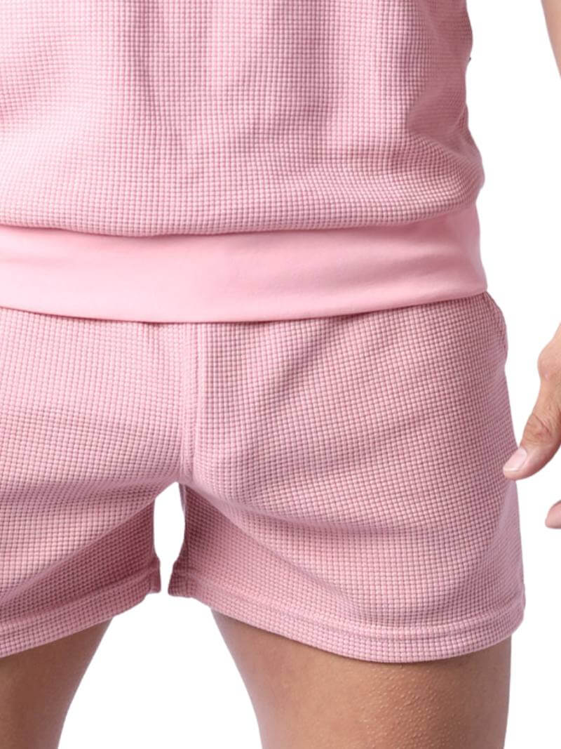 Close-up of pink checkered shorts on a white background