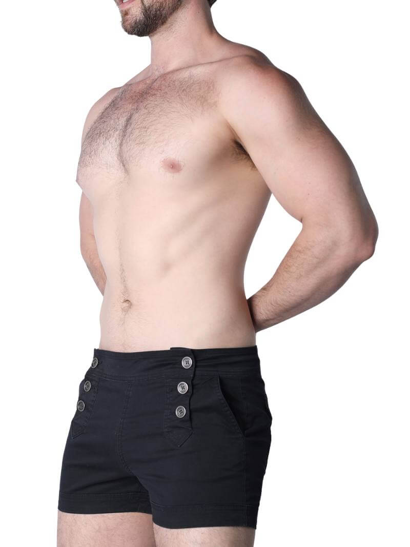 Man wearing black boxer shorts with buttons on a white background
