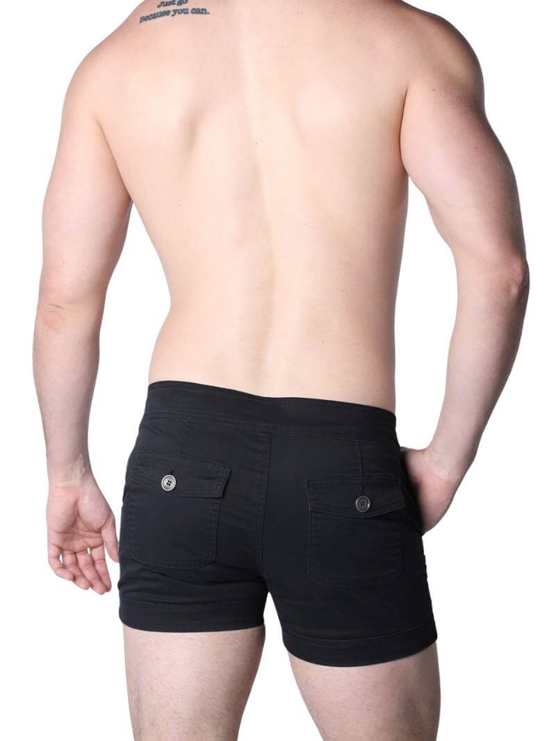 Man wearing black boxer shorts with buttons on a white background