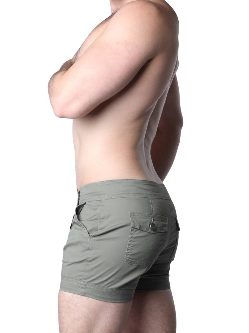 Person wearing olive green shorts on a white background