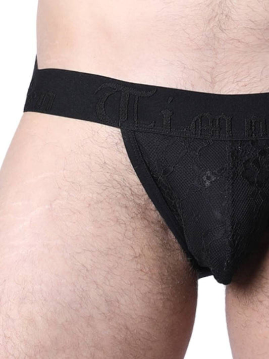 Man wearing black lace underwear in an urban setting