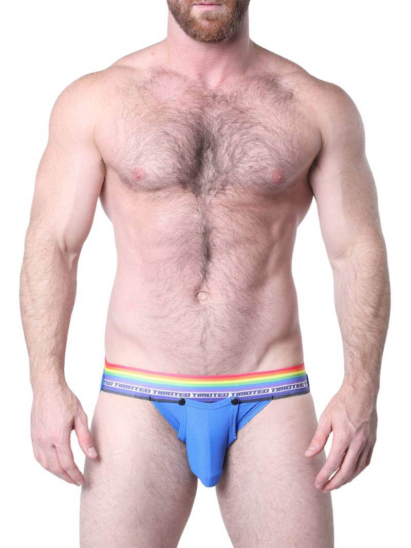 Man wearing blue underwear with a rainbow waistband on a white background