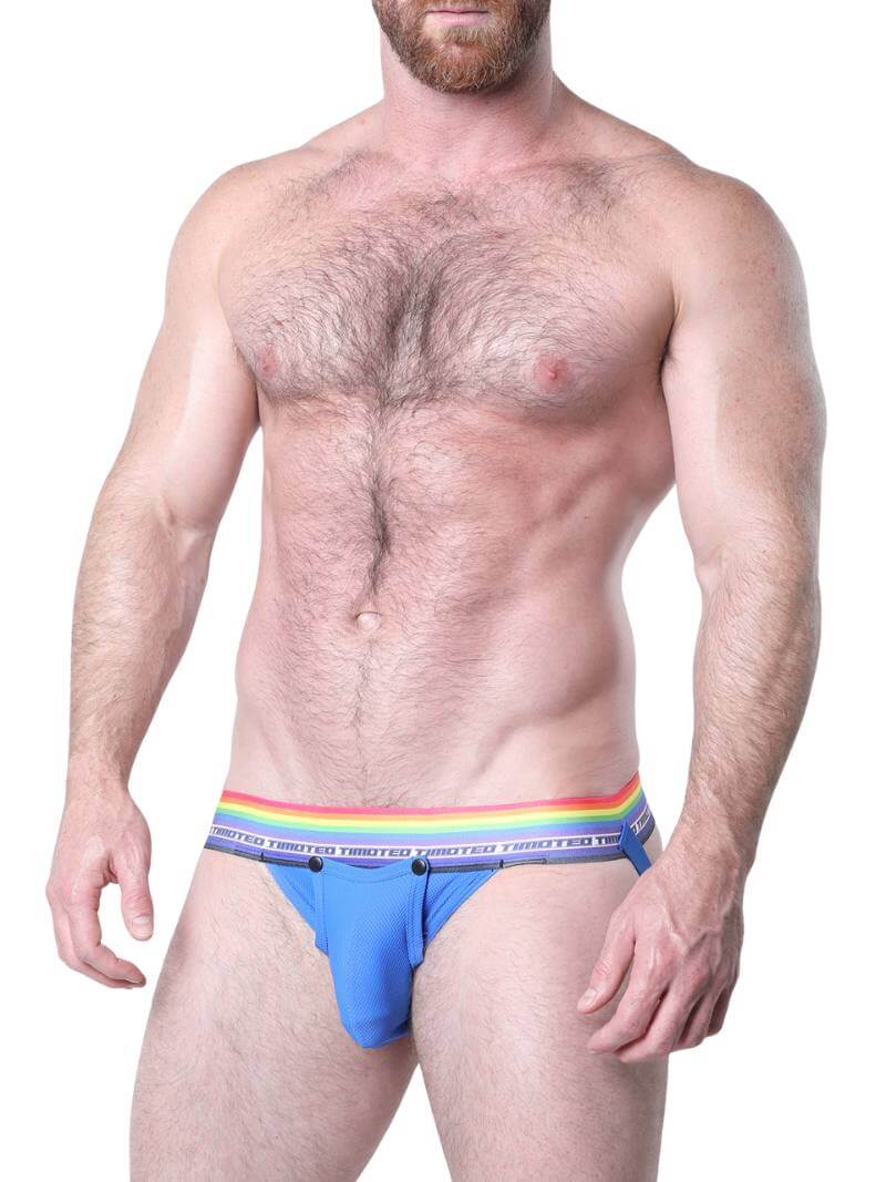 Man wearing blue underwear with a rainbow waistband on a white background