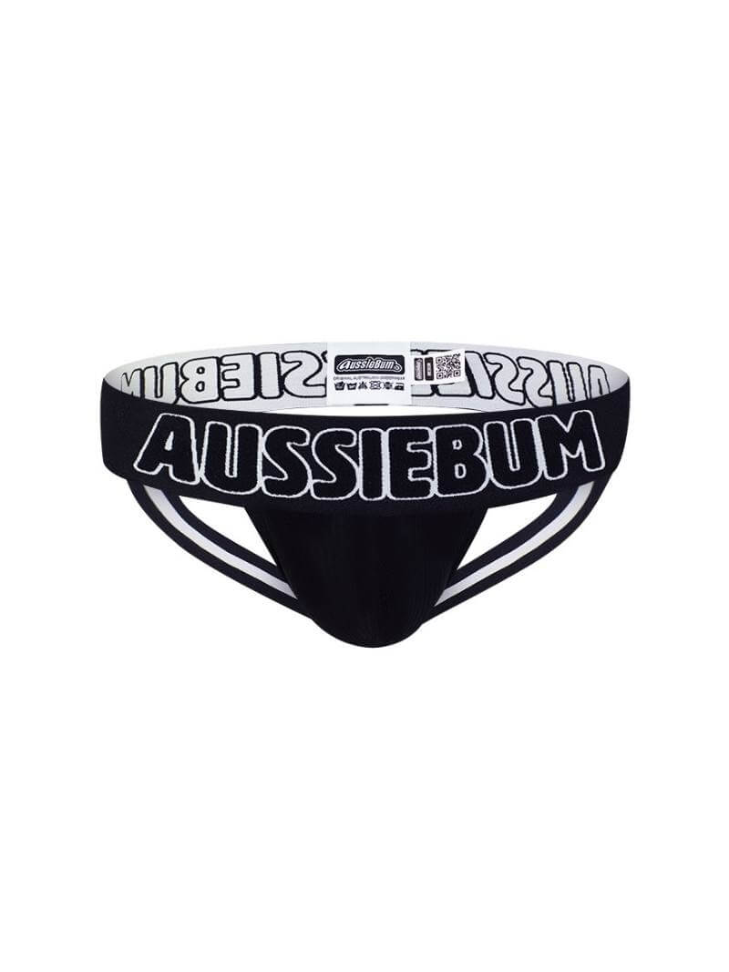 A black aussieBum X-Jock strap with prominent white aussieBum branding, featuring a thick waistband and striped design on the straps.