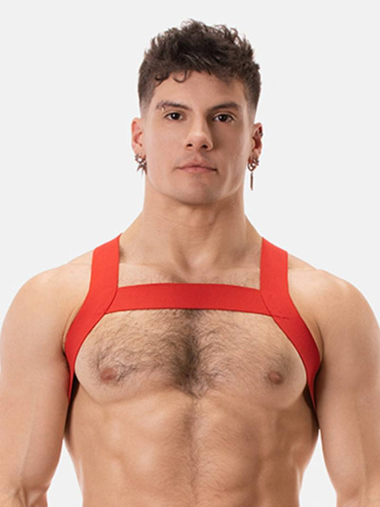 Man wearing a red chest harness against a white background