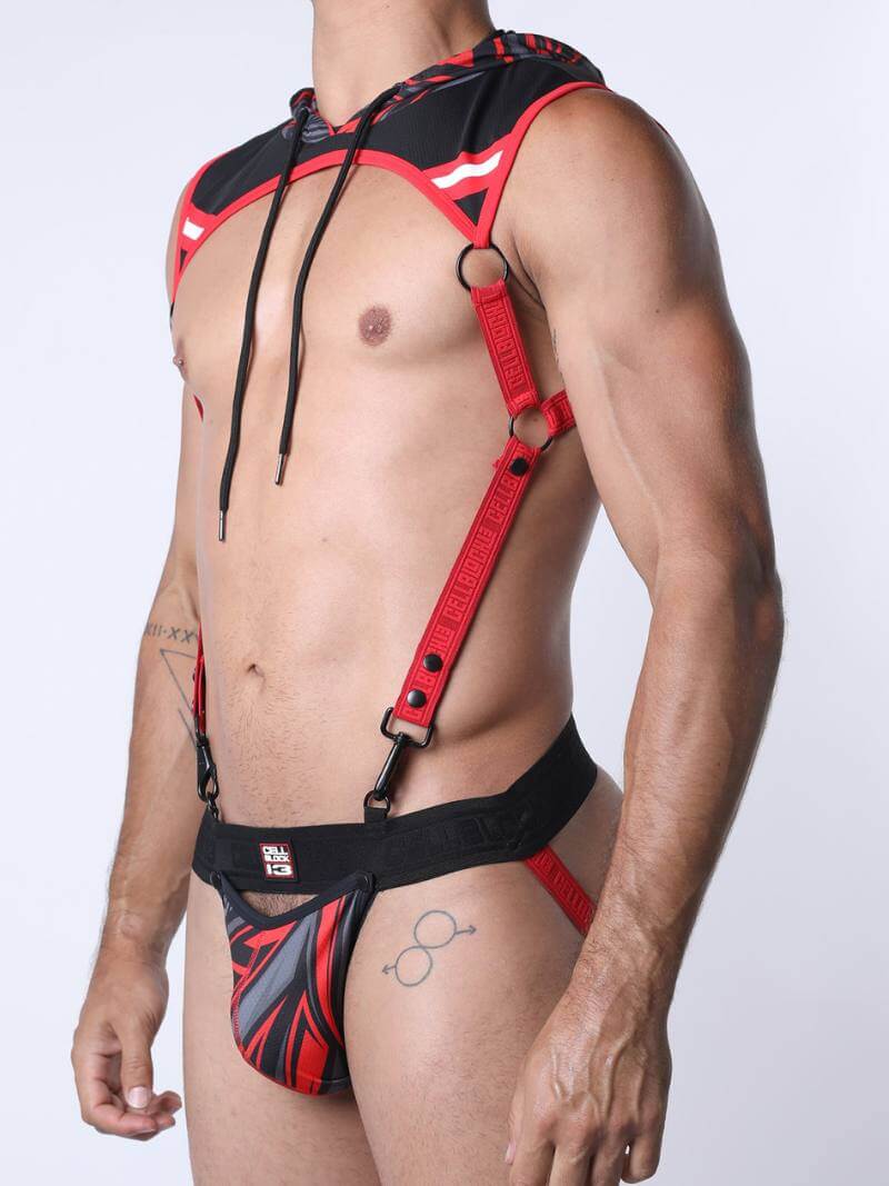 Person wearing a red and black harness against a white background