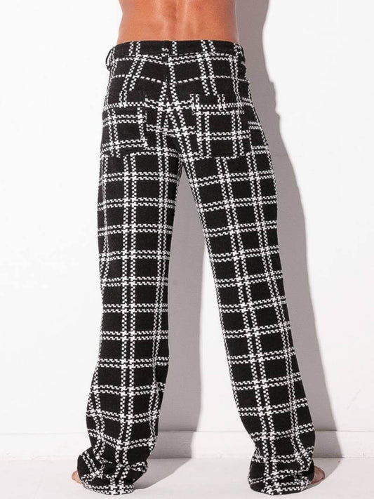 Black and white plaid pants worn by a person on a white background