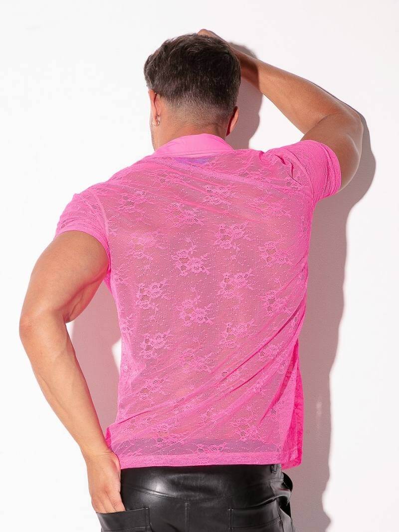 Person wearing a pink lace shirt against a white background
