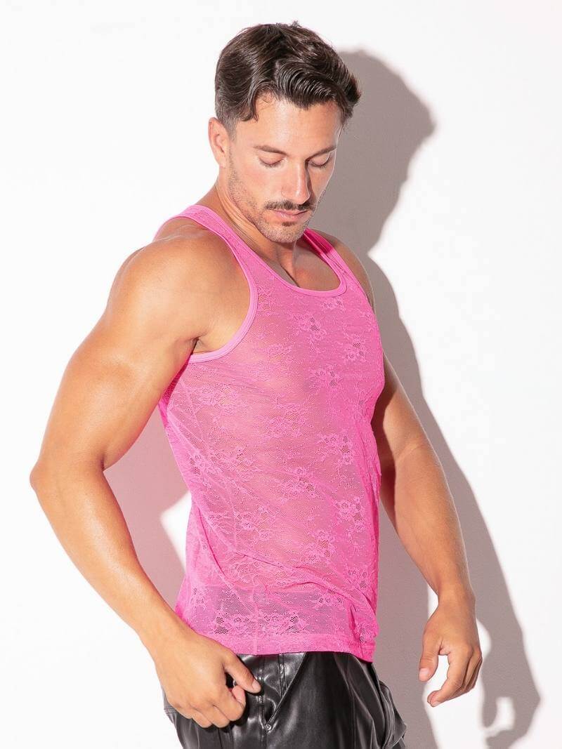 Man wearing a pink tank top against a white background