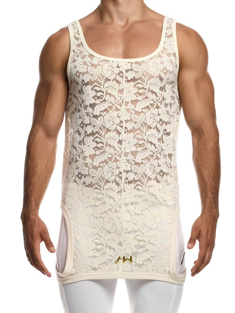 Man wearing a ivory lace tank top with white pants on a white background