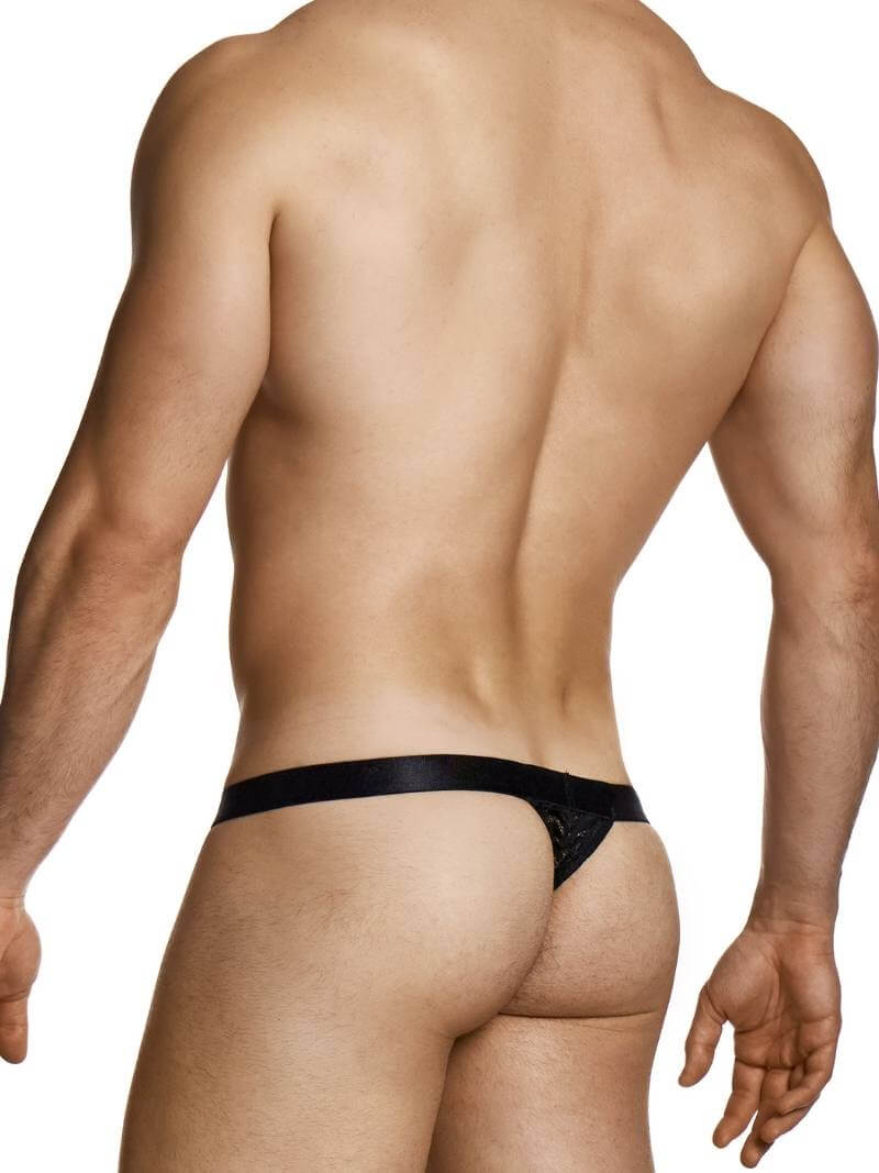 Man wearing a black thong on a white background