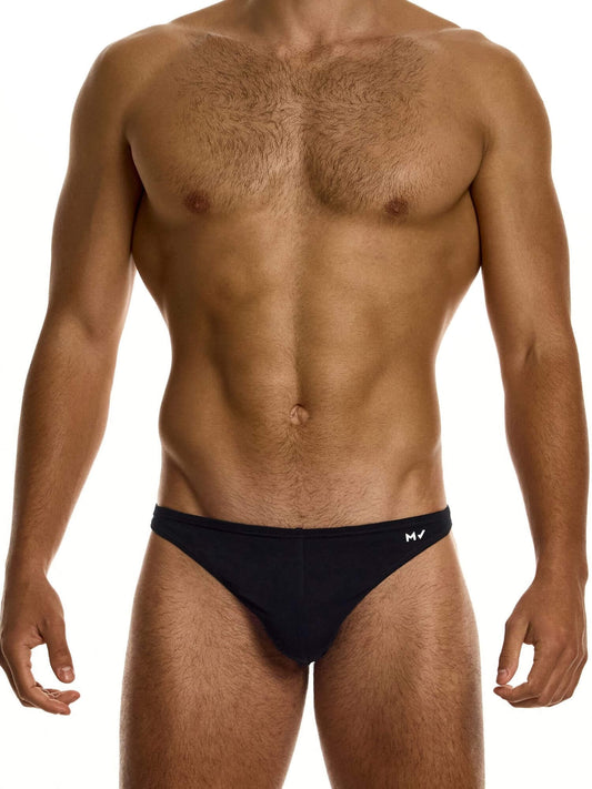 Man wearing a black super low rise brief on a white background